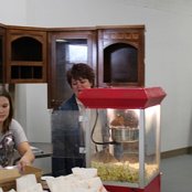 Stacey Lewis and her daughter bag the popped corn ready for guests to enjoy.