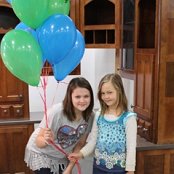 Daughers of ReStore Staffers Jim Lewis and Benji Bergstrand have the balloons ready to pass out.