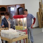 Popcorn!  ReStore Staffer Jim Lewis and his wife Stacey pop the popcorn provided by Matt Brunk, electrician for the renovation project.