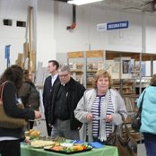 Invited guests visit the refreshment table and enjoy a bite to eat.